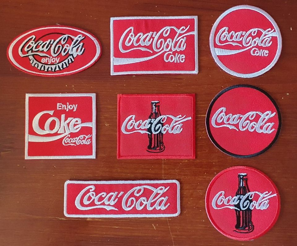 8 kpl erilaisia Coca Cola kangasmerkkejä