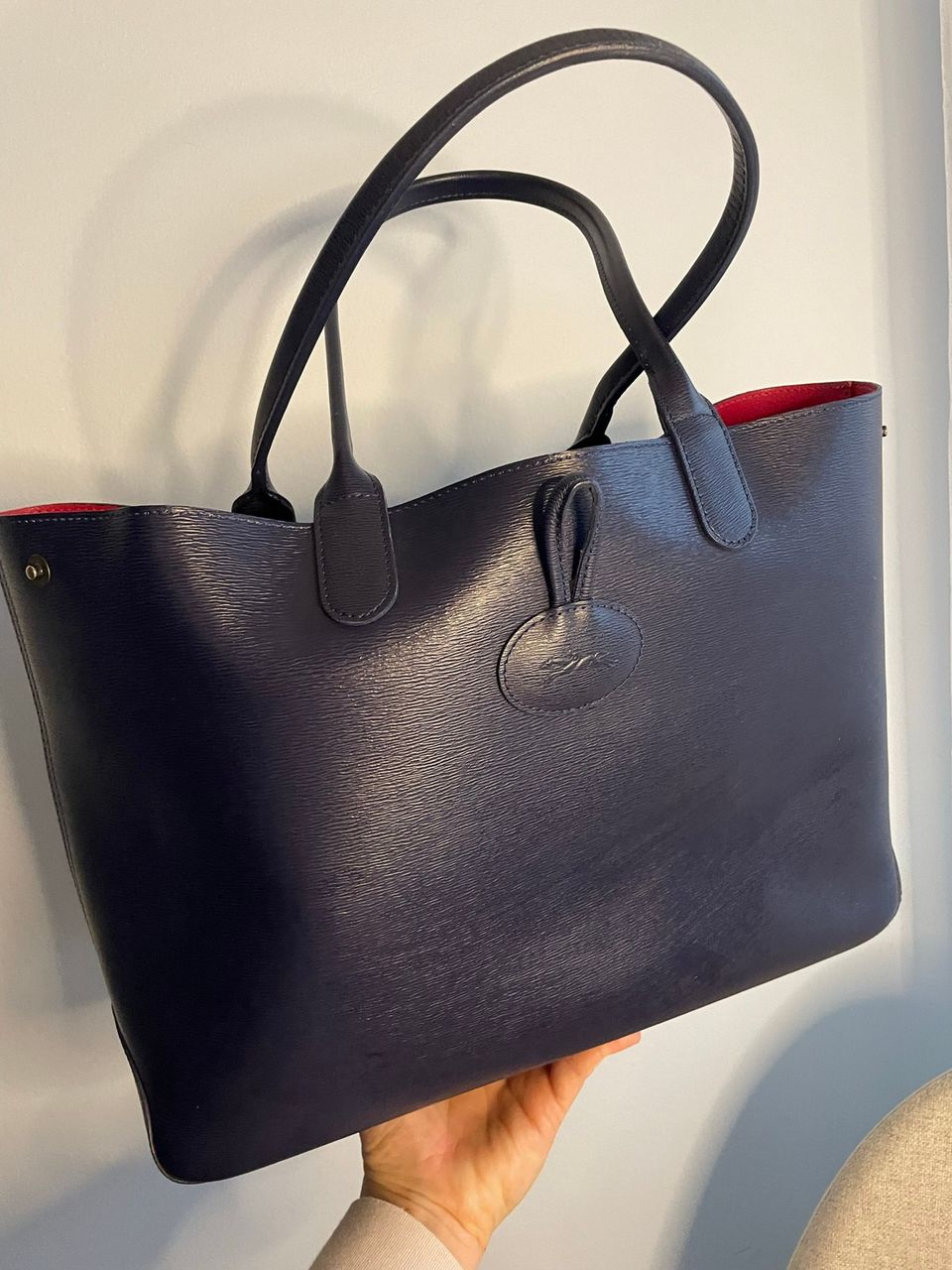 Longchamp shopper in dark blue and fuchsia pink inside.