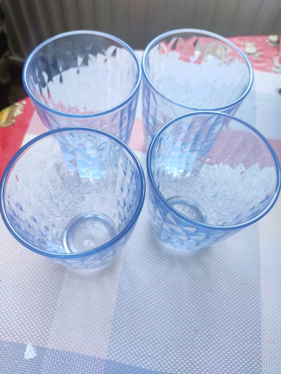 A set of 4 glasses in light blue colour