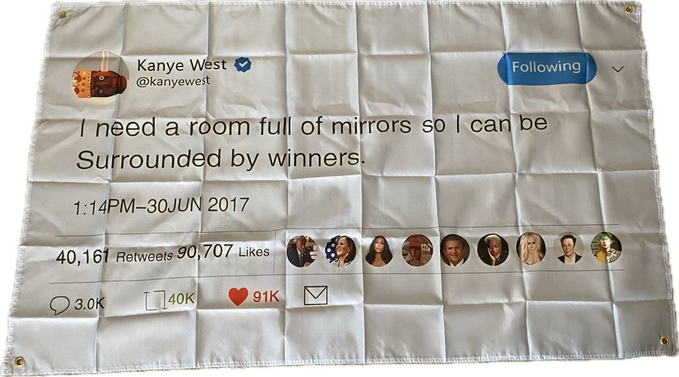 Seinälle laitettava lippu, jossa on Kanye Westin Tweettaus