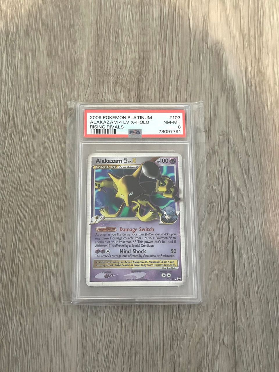 Alakazam LV. X #103 Pokemon Rising Rivals PSA 8