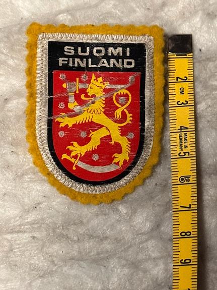 Suomen Leijona -kangas/hihamerkki