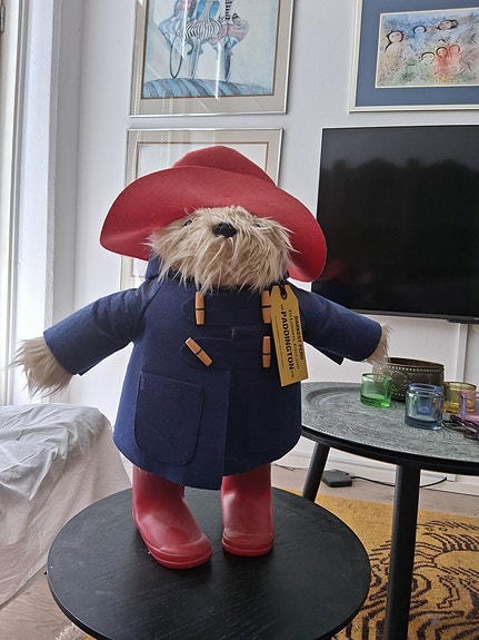 Paddington-pehmolelu punaisella hatulla ja saappailla