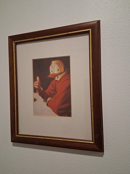 Ankka taulu puukehyksellä.