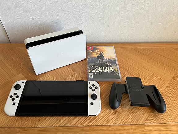 Switch OLED ja Pelejä: Zelda BotW, Super Mario Odyssey ja Mario Kart Deluxe 8.