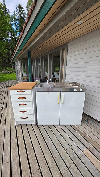 Mini keittiö. Laatikosto, hella, jääkaappi ja tiskiallas tasolla