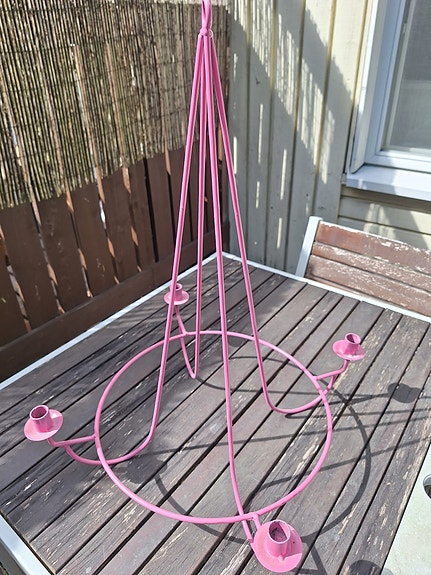 Vaaleanpunainen metallinen kynttelikkö