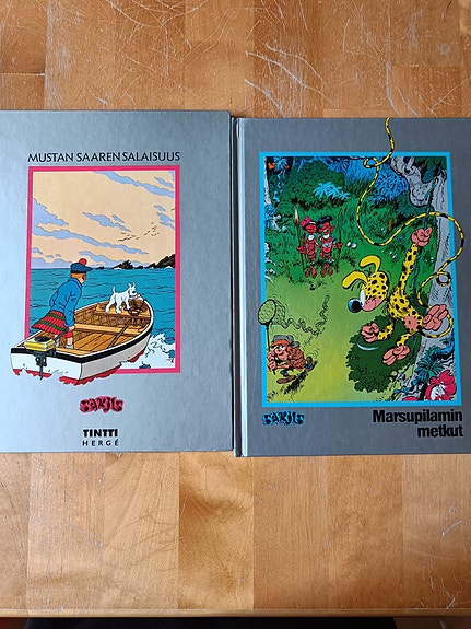Tintti Mustan saaren salaisuus ja Marsupilami -sarjakuvakirjat