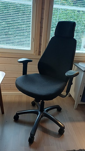 Musta toimistotuoli käsinojilla ja niskatuella