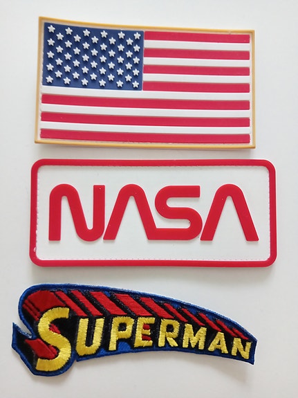 NASA, USA-lippu ja Superman kangasmerkit