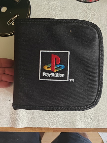 PlayStation CD-kotelo musta peleineen
