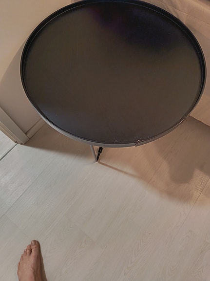 Musta pyöreä sivupöytä metallijaloilla