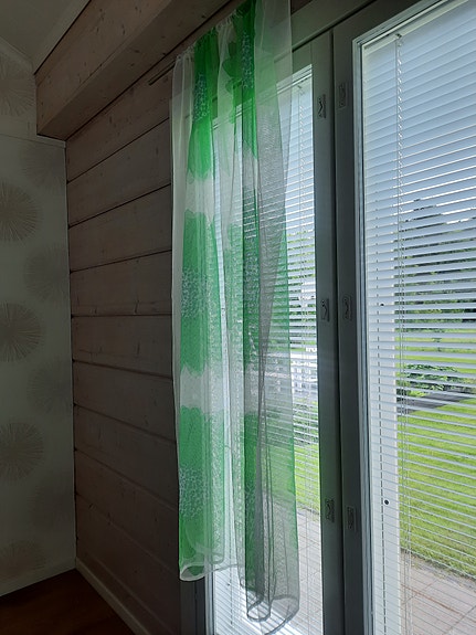 Vihreä kukkakuvioinen verho