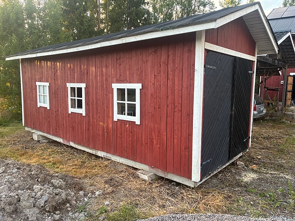 Punainen puinen varastorakennus / vaja