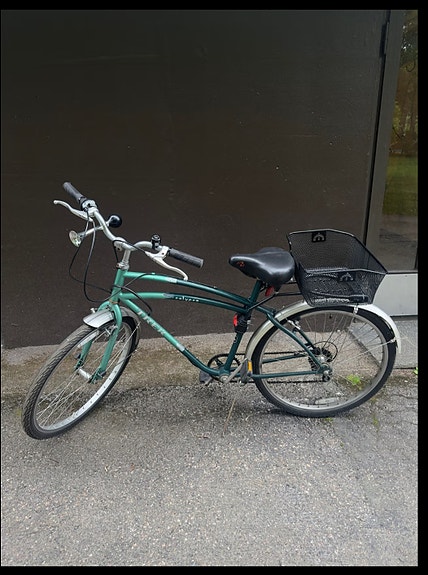 Green road bike with rear basket