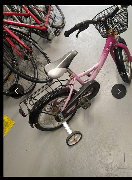 Children's pink bicycle with training wheels