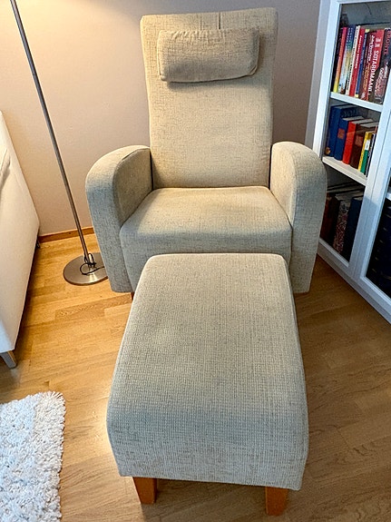 Beige nojatuoli ja rahi